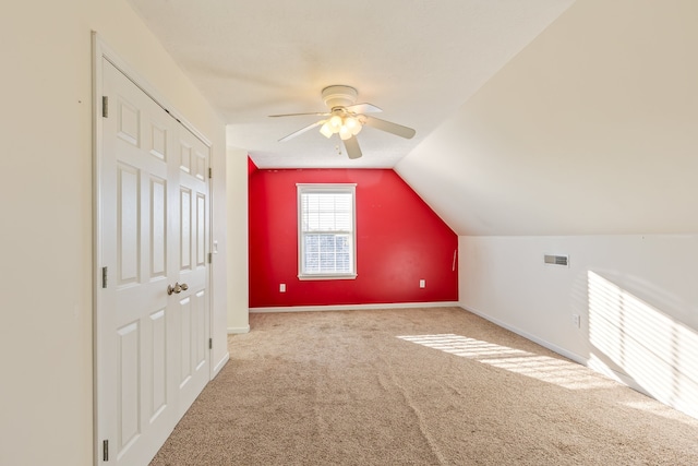 bonus room featuring ceiling fan, carpet, and vaulted ceiling