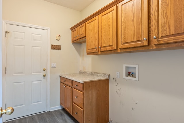 laundry room with hookup for a washing machine, dark hardwood / wood-style floors, and cabinets