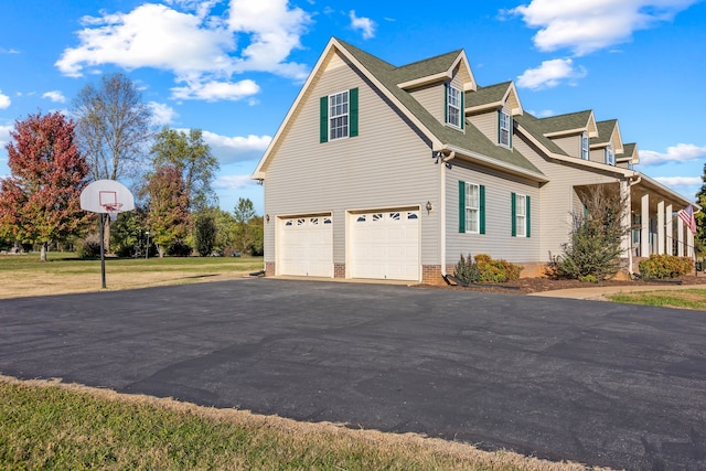 view of side of property with a lawn and a garage