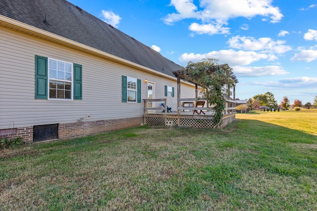 back of property featuring a yard and a deck