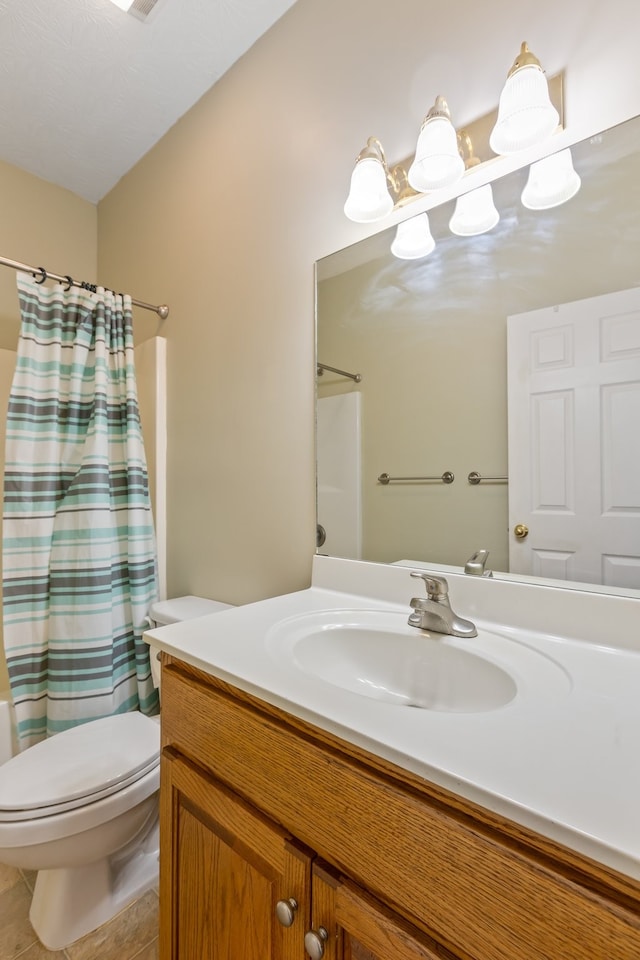 bathroom featuring toilet, curtained shower, vanity, and tile patterned flooring