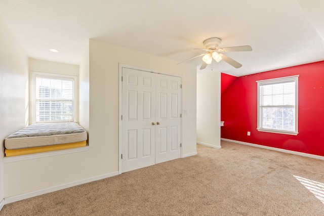 unfurnished bedroom featuring a closet, ceiling fan, and carpet flooring