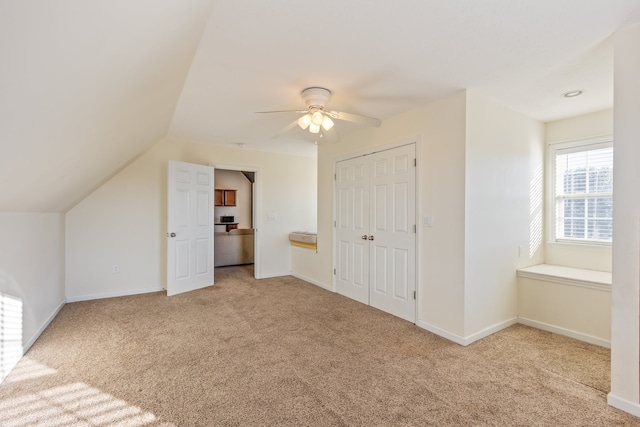 bonus room with ceiling fan, vaulted ceiling, and light colored carpet