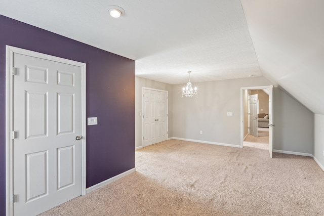 interior space with lofted ceiling and a chandelier