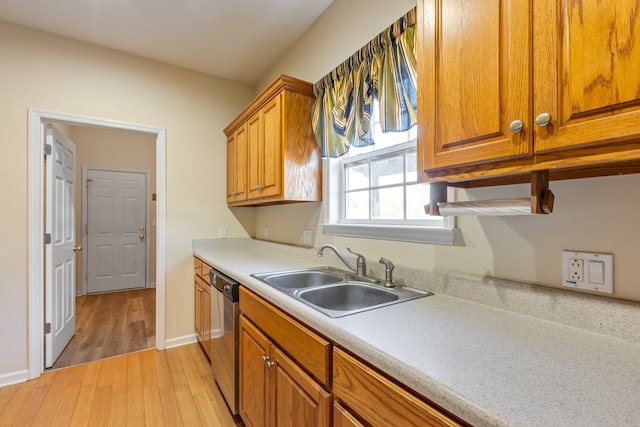 kitchen featuring light hardwood / wood-style flooring, dishwasher, and sink