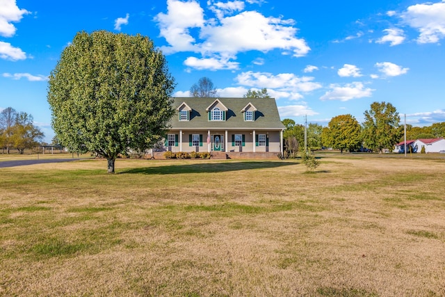 cape cod home featuring a porch and a front lawn