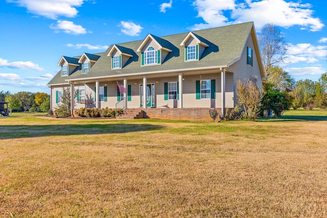 cape cod house featuring covered porch and a front lawn