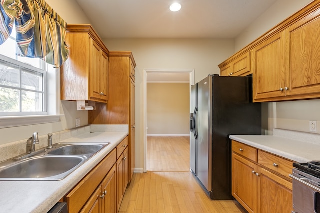 kitchen featuring light hardwood / wood-style floors, sink, and stainless steel appliances