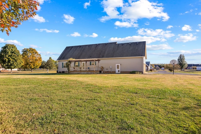 back of house with a lawn