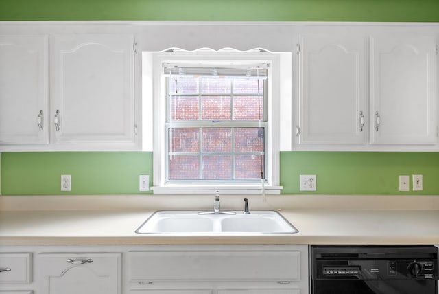 kitchen with black dishwasher, sink, and white cabinets