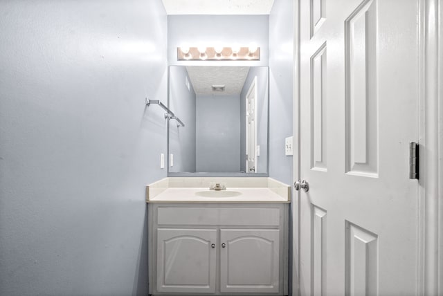 bathroom featuring vanity and a textured ceiling