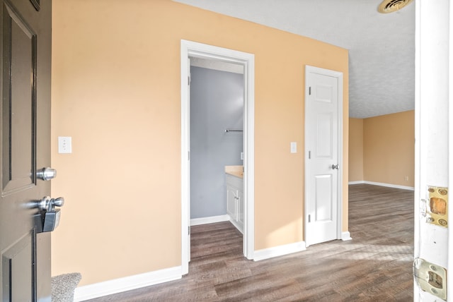 interior space featuring a textured ceiling and hardwood / wood-style flooring