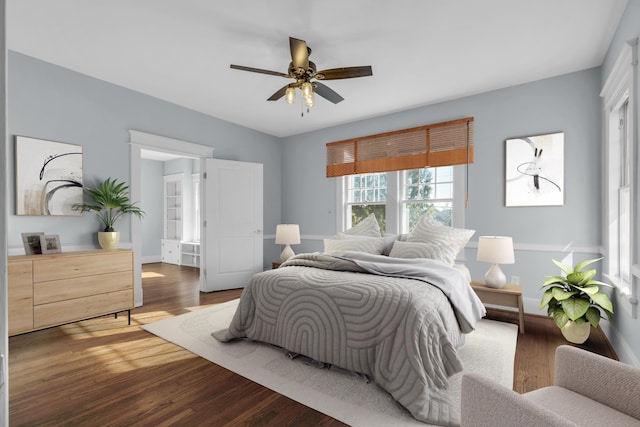 bedroom featuring ceiling fan and dark hardwood / wood-style floors