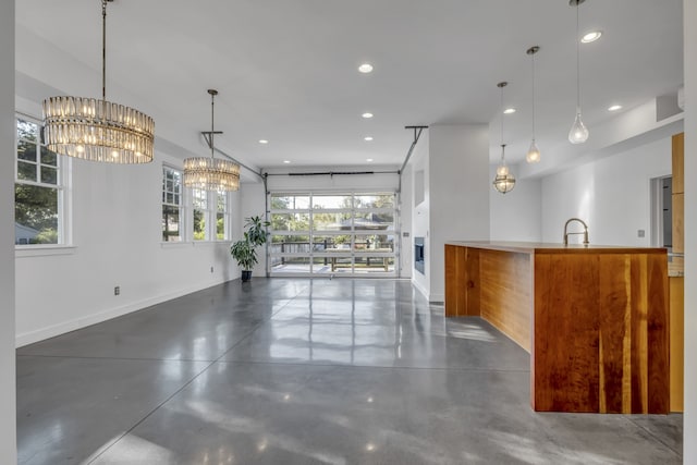 kitchen featuring plenty of natural light, decorative light fixtures, and sink