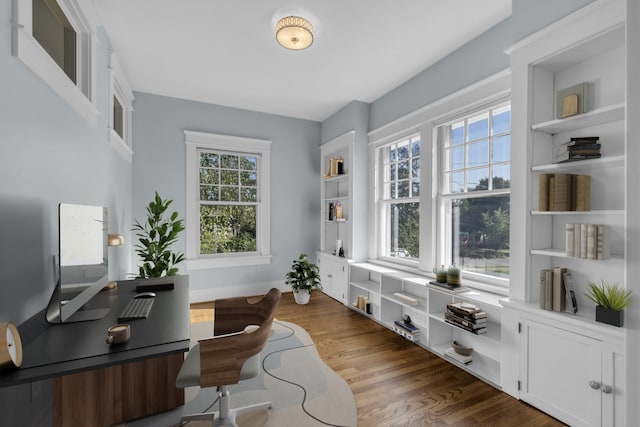 home office with dark hardwood / wood-style flooring