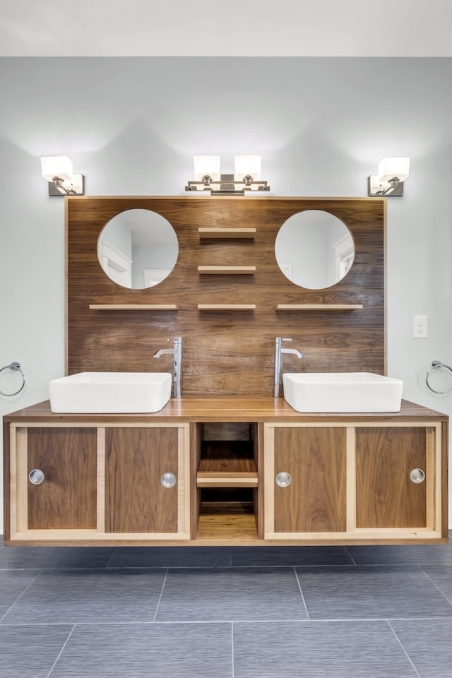 bathroom featuring tile patterned flooring and vanity