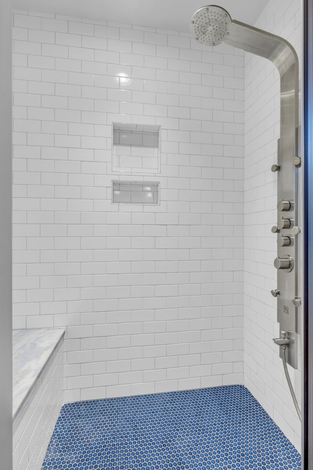 bathroom with tiled shower