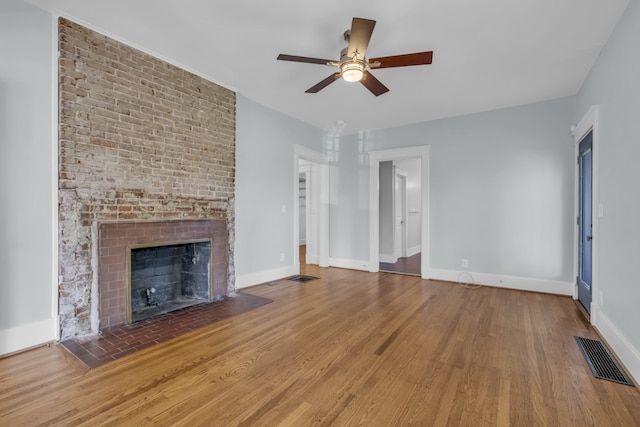 unfurnished living room with a fireplace, ceiling fan, and hardwood / wood-style floors