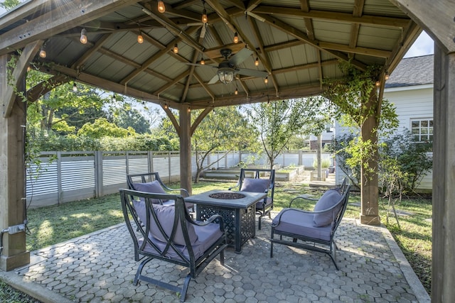 view of patio / terrace with a gazebo, ceiling fan, and an outdoor fire pit