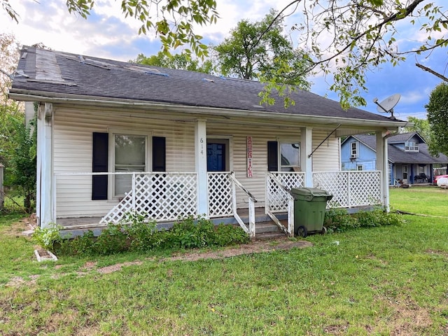 614 Tater Peeler Rd, Lebanon, TN 37087 - view of front of home with covered porch, a front yard, and roof with shingles