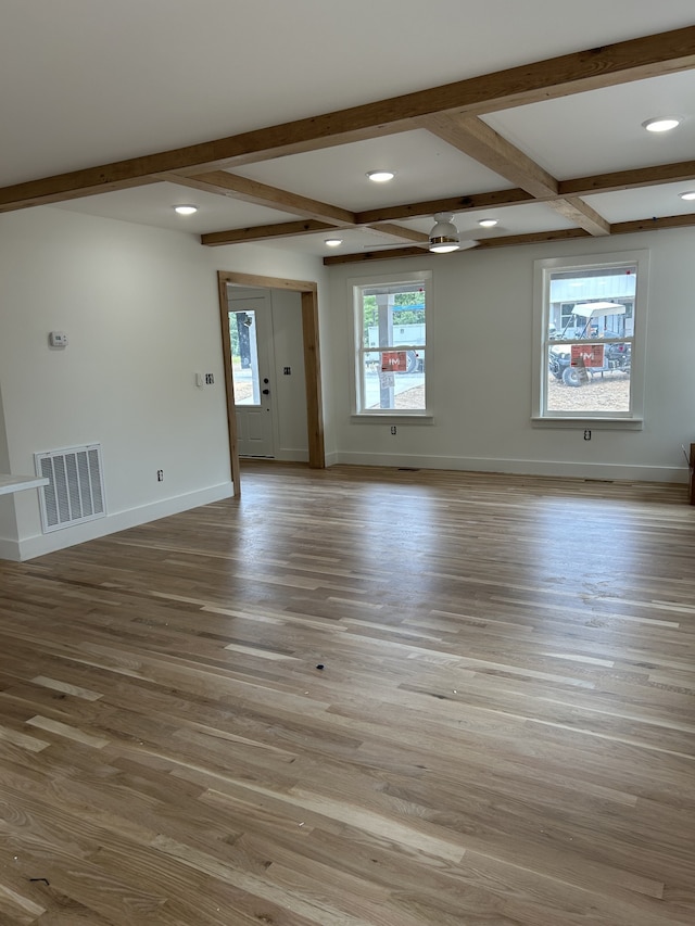 spare room with a wealth of natural light, beamed ceiling, light hardwood / wood-style floors, and coffered ceiling