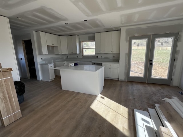 kitchen with dark hardwood / wood-style flooring, a center island, and white cabinetry