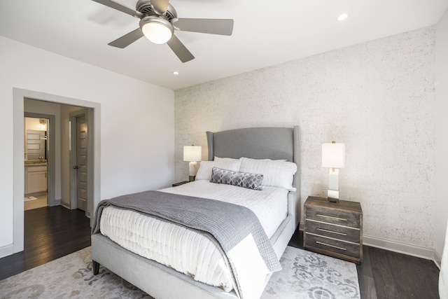 bedroom featuring ensuite bathroom, dark hardwood / wood-style flooring, and ceiling fan