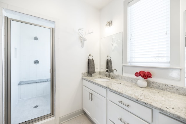 bathroom featuring an enclosed shower and vanity