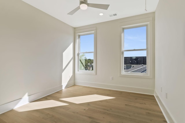 unfurnished room with ceiling fan and light hardwood / wood-style flooring