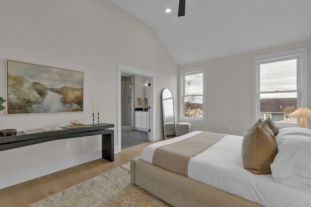 bedroom with hardwood / wood-style flooring, ensuite bath, high vaulted ceiling, and ceiling fan