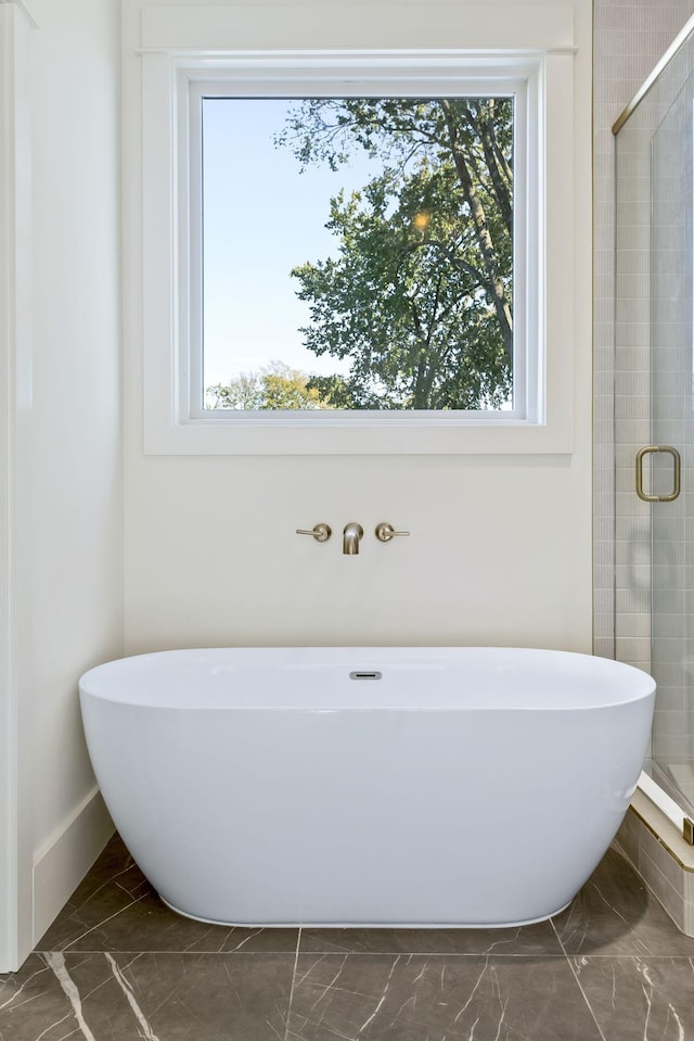 bathroom featuring separate shower and tub