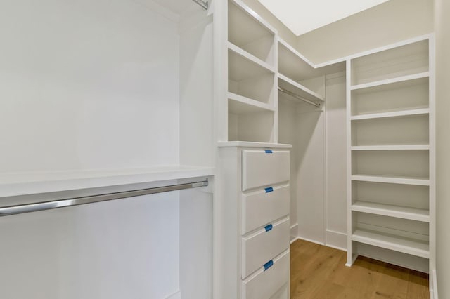 walk in closet featuring light hardwood / wood-style flooring