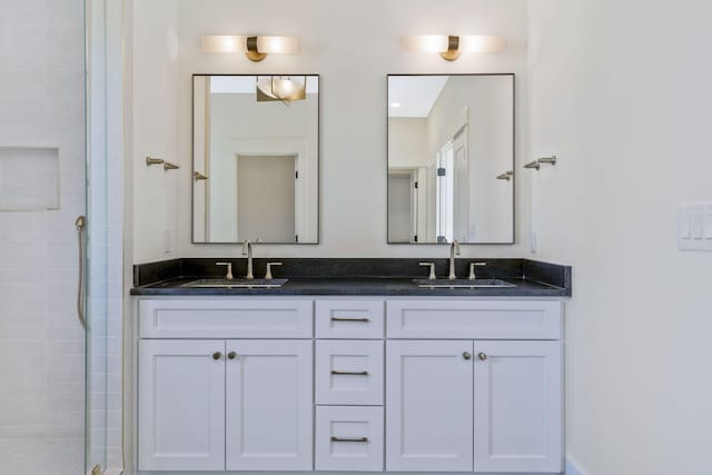 bathroom featuring vanity and an enclosed shower