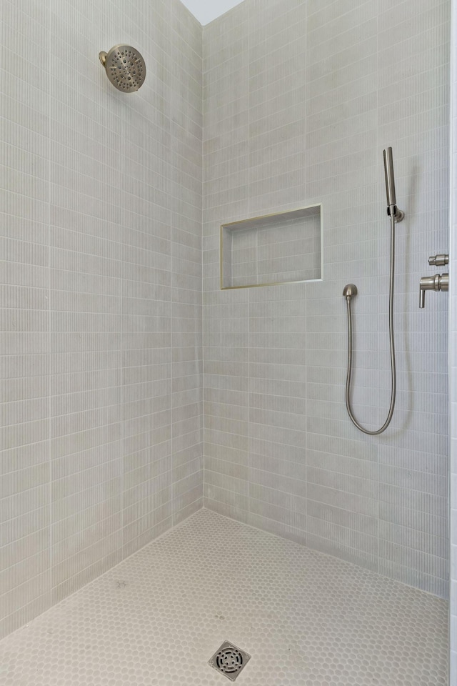 bathroom with a tile shower