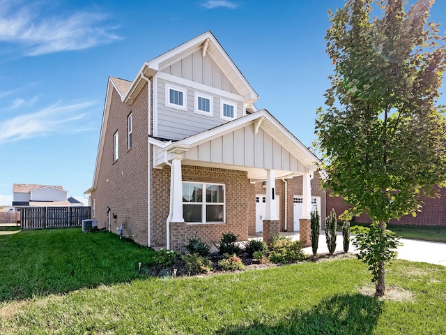 craftsman-style house featuring cooling unit, a front yard, and a garage