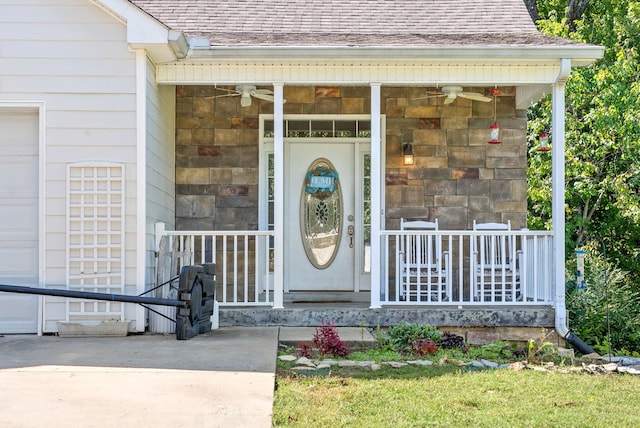 property entrance featuring ceiling fan, a garage, and a porch