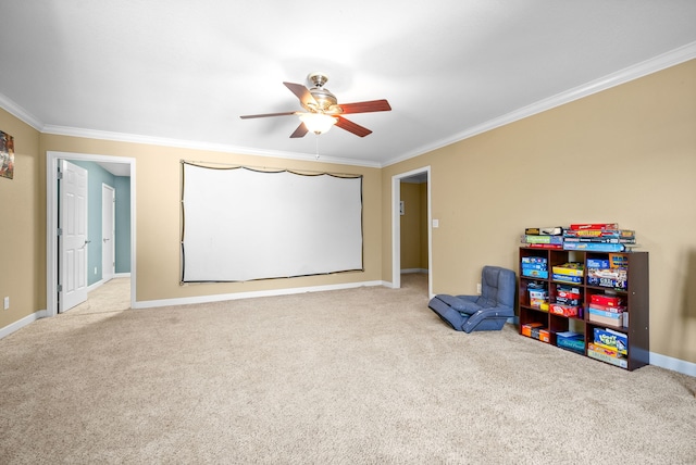 game room featuring ornamental molding, ceiling fan, and light colored carpet