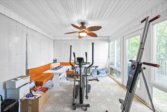 exercise area featuring ceiling fan and light carpet