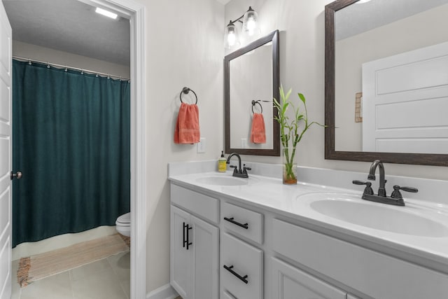 bathroom with a shower with curtain, vanity, tile patterned floors, toilet, and a textured ceiling