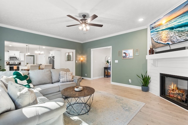 living room featuring ceiling fan, light wood-type flooring, and crown molding