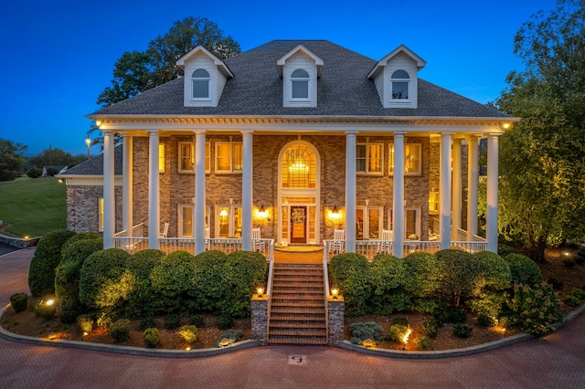 neoclassical / greek revival house featuring covered porch