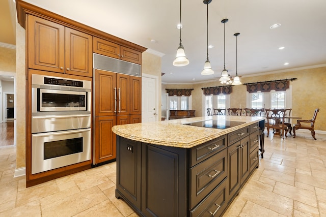 kitchen featuring an island with sink, hanging light fixtures, ornamental molding, paneled fridge, and black electric stovetop