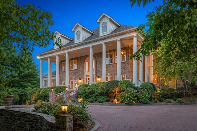 neoclassical home featuring a porch