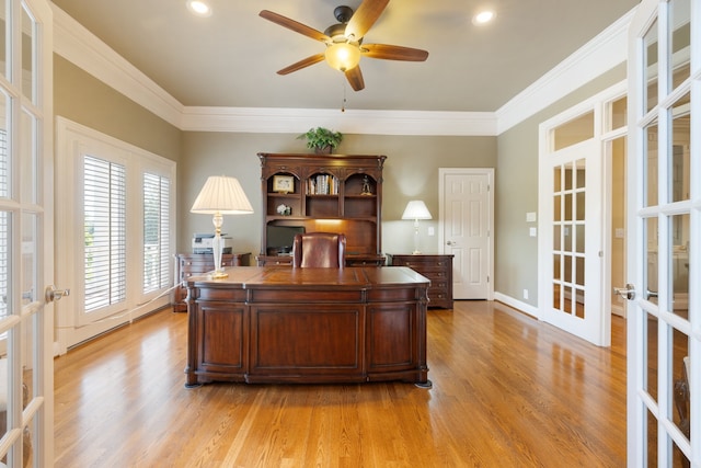 home office with french doors, crown molding, and light hardwood / wood-style floors