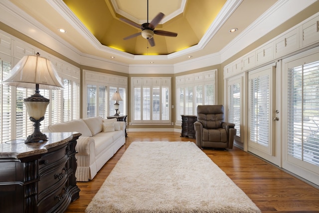 living room with hardwood / wood-style flooring, crown molding, and a wealth of natural light