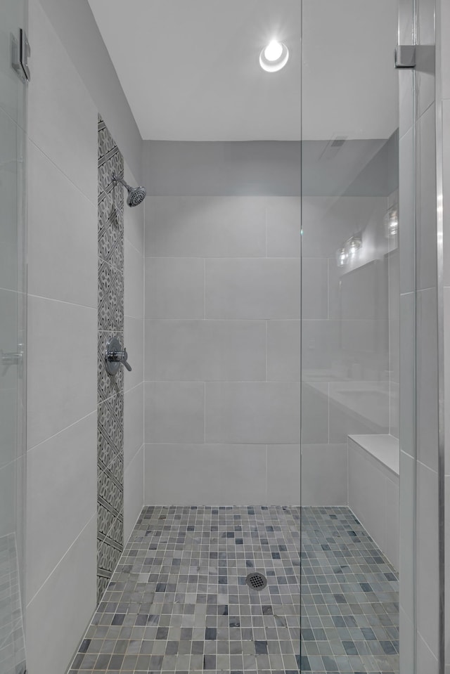 bathroom with a tile shower