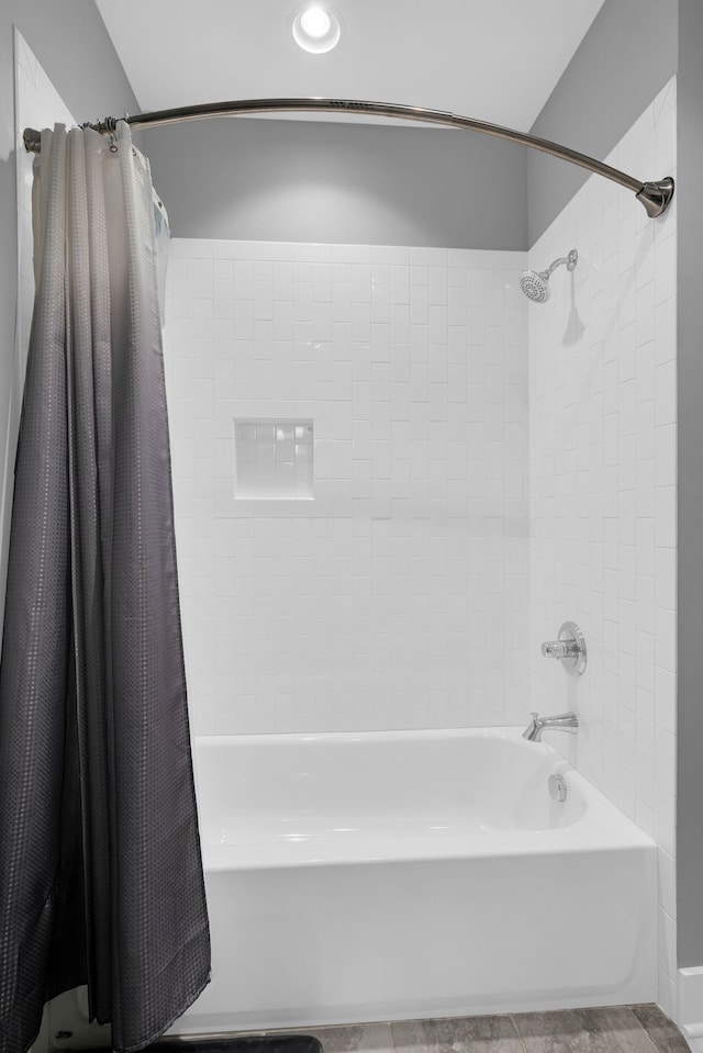 bathroom with shower / bath combination with curtain