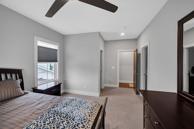 bedroom with ceiling fan and light colored carpet