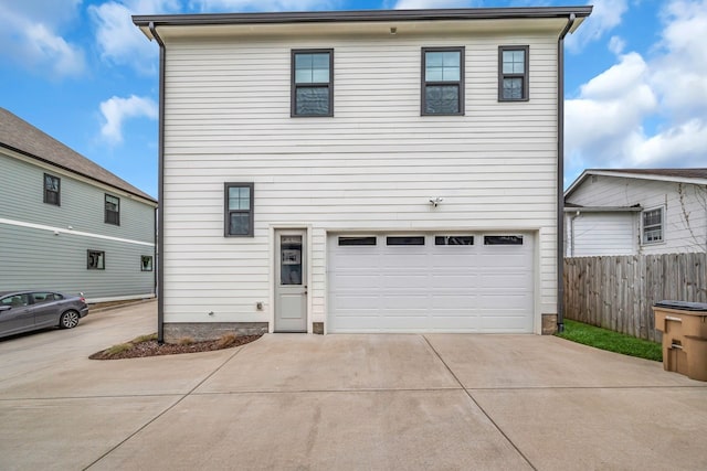 rear view of house with a garage