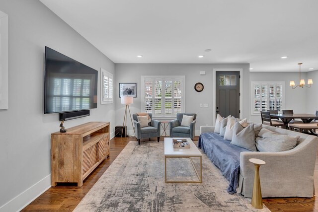 living room featuring hardwood / wood-style flooring and a chandelier